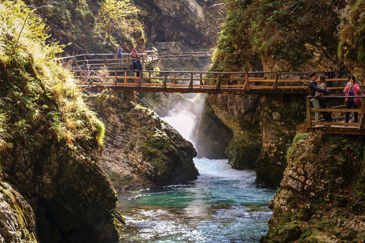 People stand on the wooden bridges inside Vintgar Gorge.