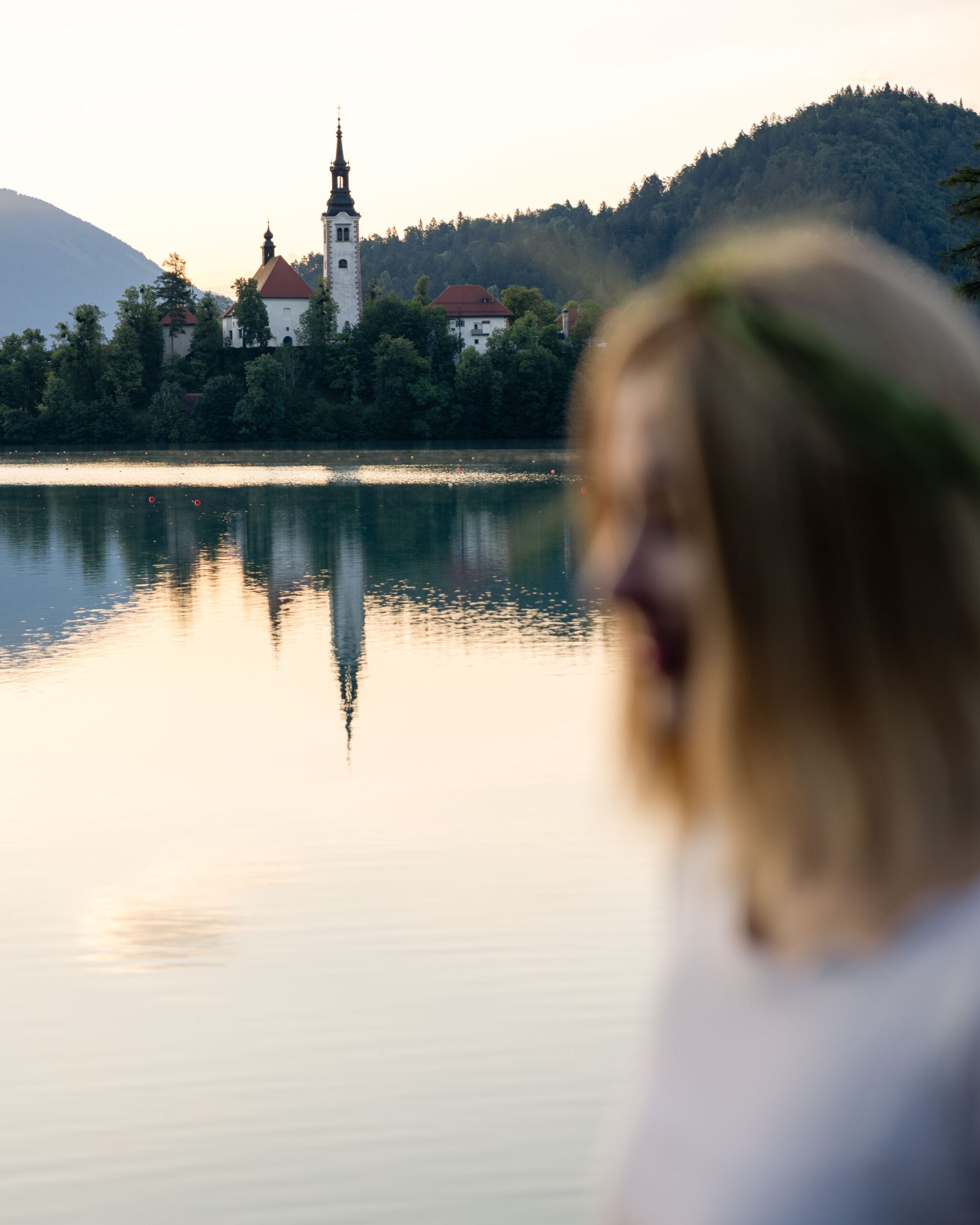A woman standing by Lake Bled