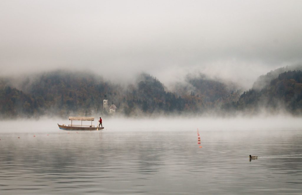 Pletna boat at Lake Bled on a misty morning