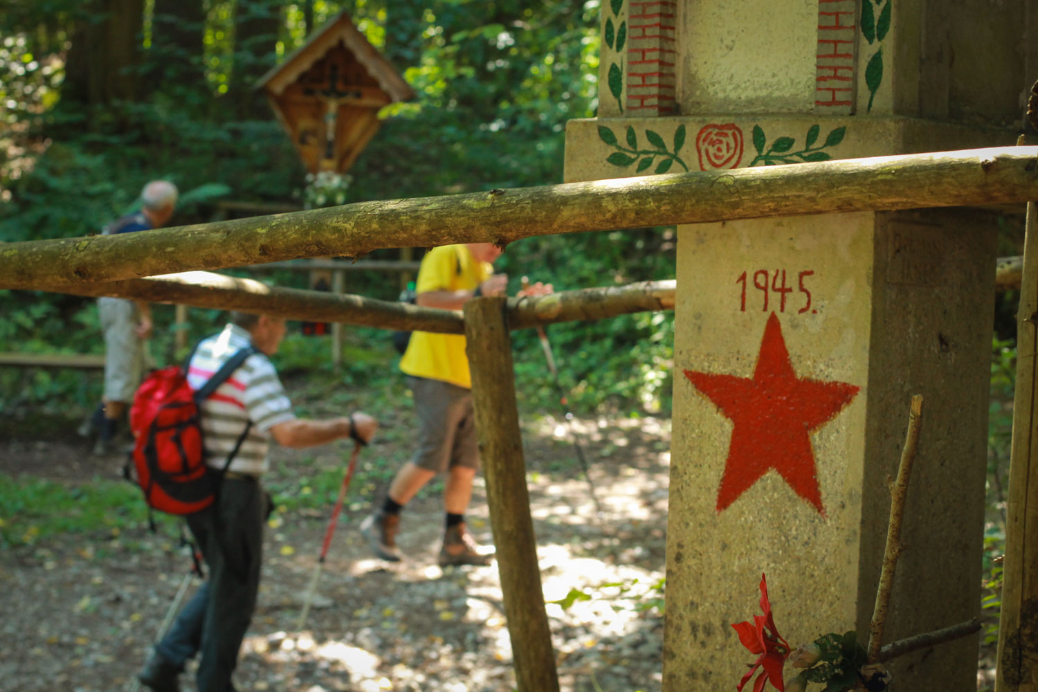 Wooden cross and a Partisan memorial  by the hiking trail to Talež Hut