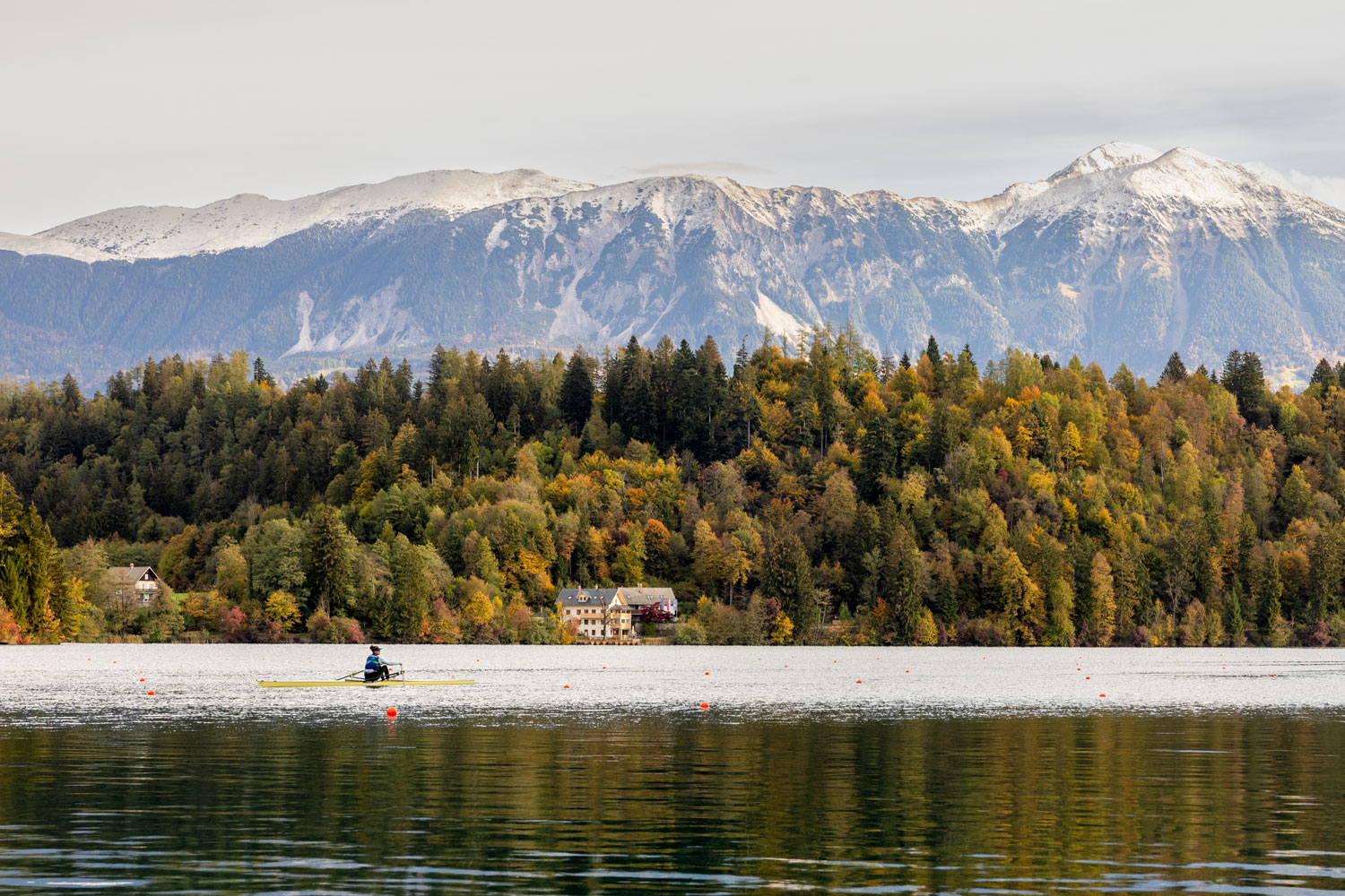 A woman rows at Lake Bled in autumn