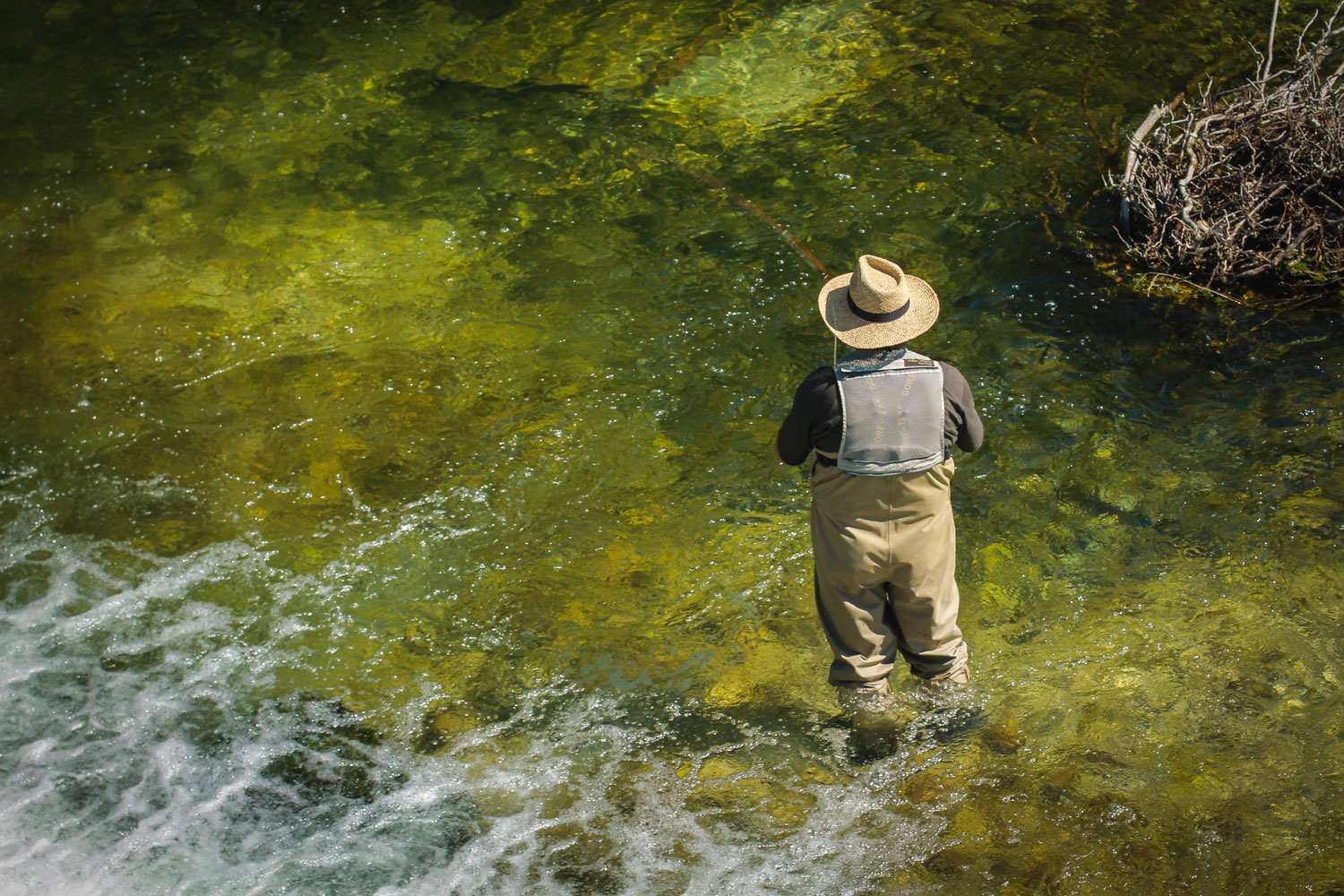 A fisherman seen below the Ribno bridge across Sava Bohnjka River. 