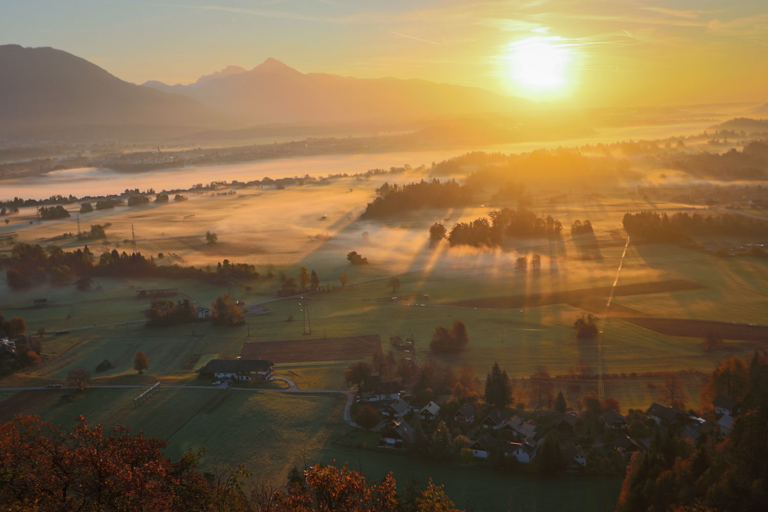 View called Dindol on Straža Hill in Bled looking across a wide landscape with mountain ranges in the distance.